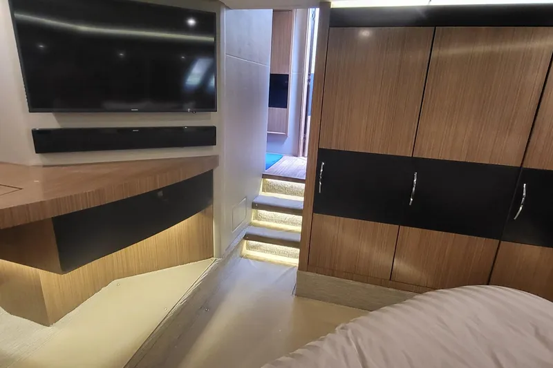 Slide: The Image of Luxurious interior of 2018 Sea Ray L590 Fly yacht with modern wood cabinetry and flat-screen TV. - 58