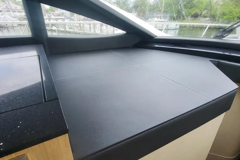 Slide: The Image of Interior view of 2018 Sea Ray L590 Fly yacht with sleek black dashboard. - 61
