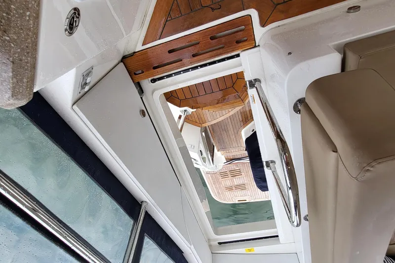 Slide: The Image of Interior view of 2018 Sea Ray L590 Fly yacht with wooden flooring and seating. - 62