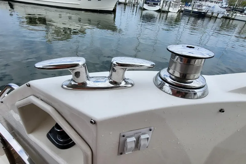 Slide: The Image of 2018 Sea Ray L590 Fly yacht deck with cleat and winch by the water. - 65