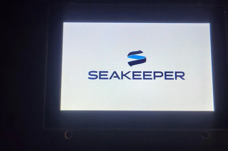 Slide: The Image of Seakeeper logo on display screen, Sea Ray L590 Fly 2018 model. - 67