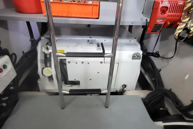 Slide: The Image of Engine room of 2018 Sea Ray L590 Fly yacht with equipment and ladder. - 69