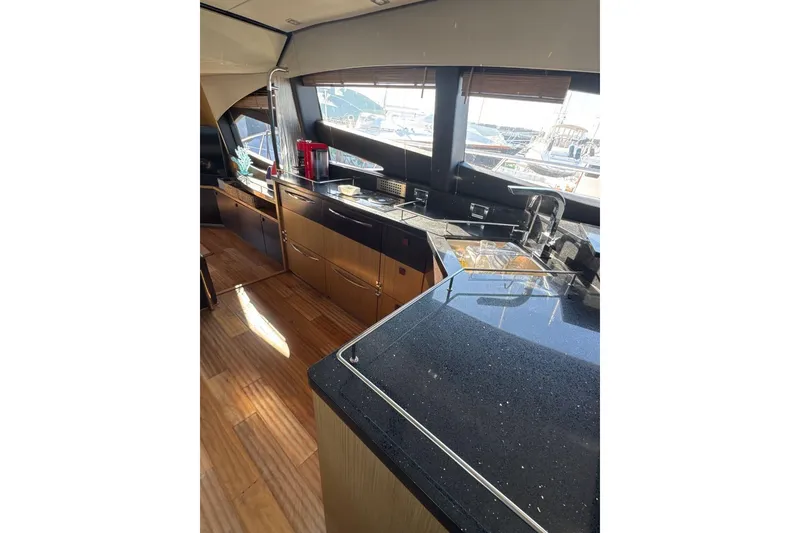 Slide: The Image of Luxurious interior of 2018 Sea Ray L590 Fly yacht with modern kitchen design. - 7