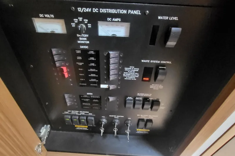 Slide: The Image of Control panel of a 2018 Sea Ray L590 Fly yacht, showing DC distribution and system controls. - 74