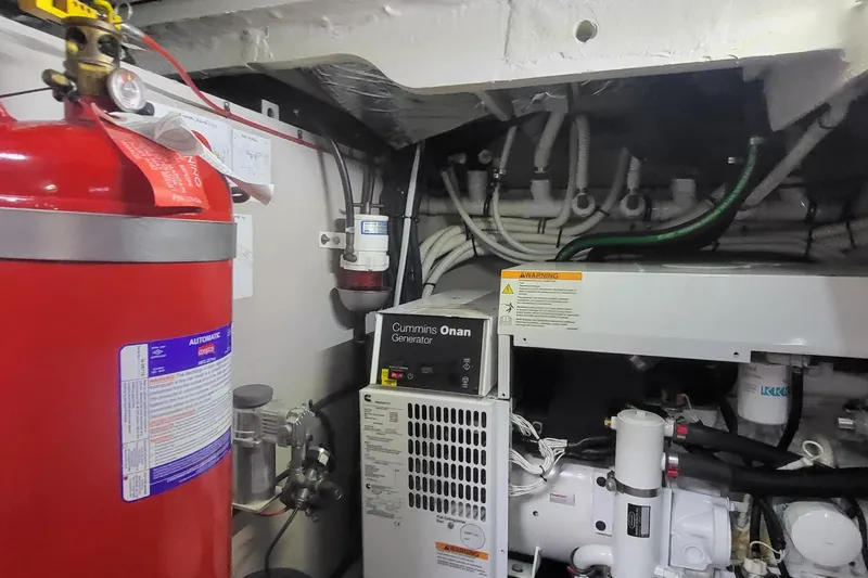 Slide: The Image of Engine room of 2018 Sea Ray L590 Fly with Cummins Onan generator and fire extinguisher. - 76