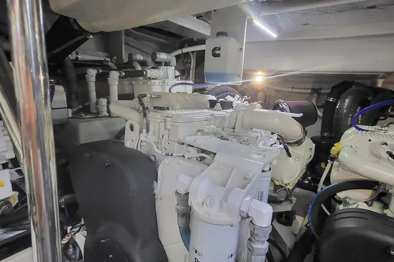 Slide: The Image of Engine room of 2018 Sea Ray L590 Fly yacht, showcasing mechanical components and systems. - 77