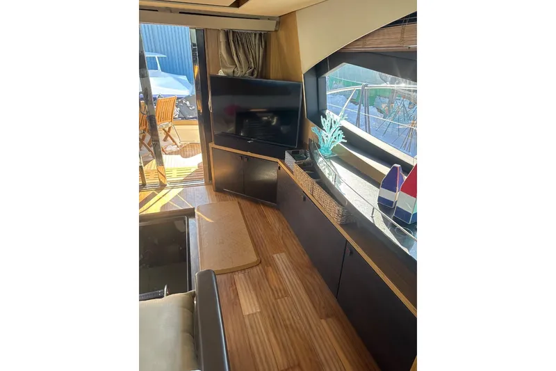 Slide: The Image of Interior of 2018 Sea Ray L590 Fly yacht with modern decor and wooden flooring. - 8