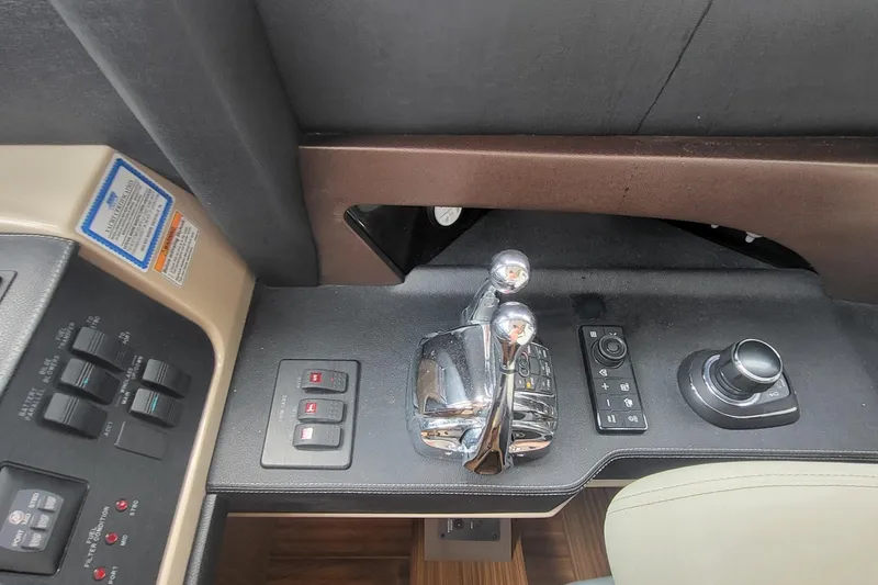 Slide: The Image of Control panel of 2018 Sea Ray L590 Fly yacht with throttle and navigation controls. - 82