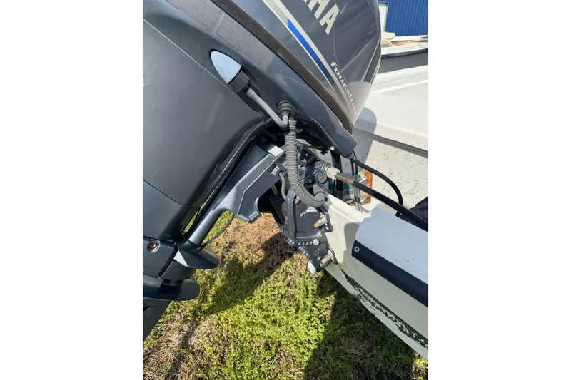 Slide: The Image of 1998 Carolina Skiff 16 with Yamaha outboard motor, parked on grass. - 10