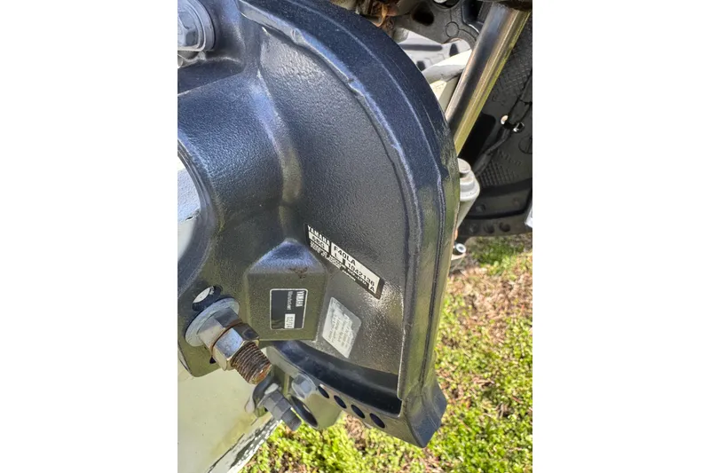 Slide: The Image of Close-up of a 1998 Carolina Skiff 16 boat motor component with visible labels. - 11
