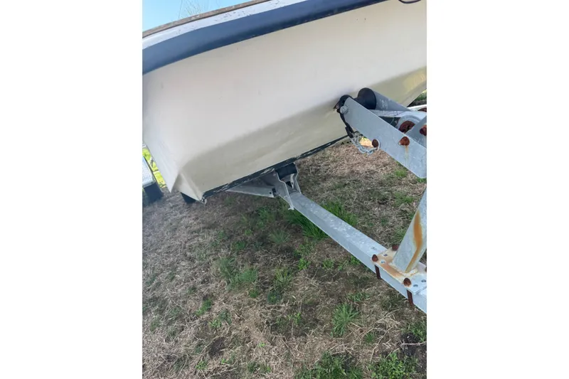 Slide: The Image of 1998 Carolina Skiff 16 boat on trailer, showing hull and trailer details. - 12