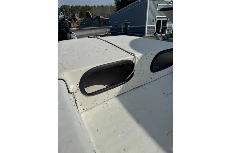 Slide: The Image of 1998 Carolina Skiff 16 boat detail showing weathered surface and rope. - 3