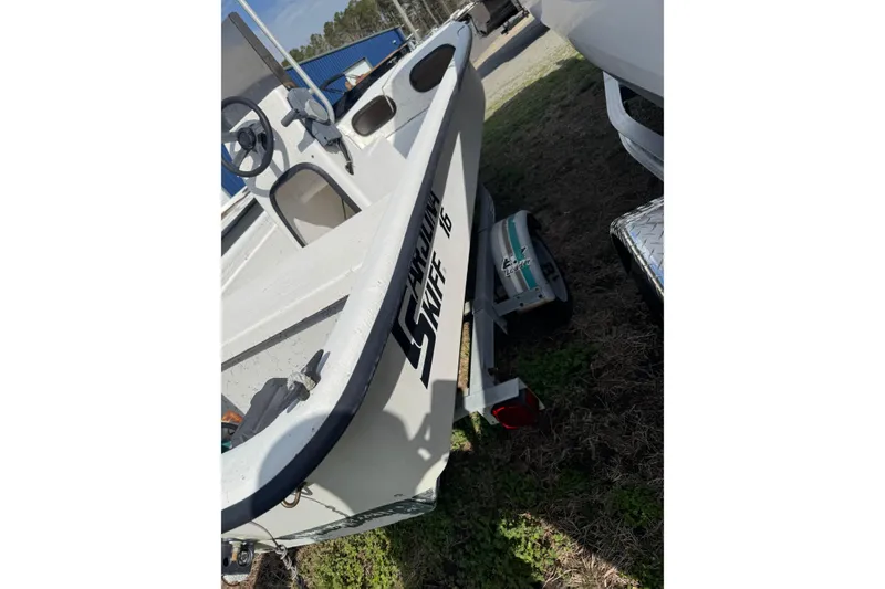 Slide: The Image of 1998 Carolina Skiff 16 boat on trailer, parked outdoors. - 4