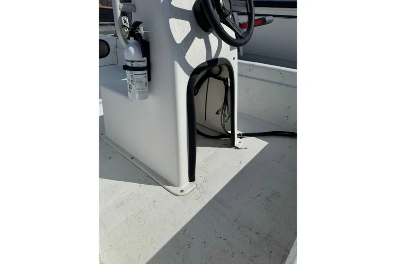 Slide: The Image of 1998 Carolina Skiff 16 boat interior with steering console and fire extinguisher. - 6