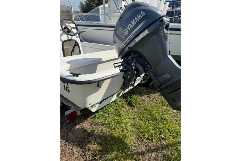 Slide: The Image of 1998 Carolina Skiff 16 boat with Yamaha outboard motor on grassy area. - 8