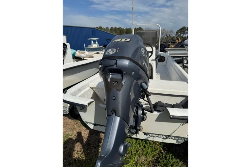 Slide: The Image of 1998 Carolina Skiff 16 boat with Yamaha 40HP outboard motor, parked outdoors. - 9