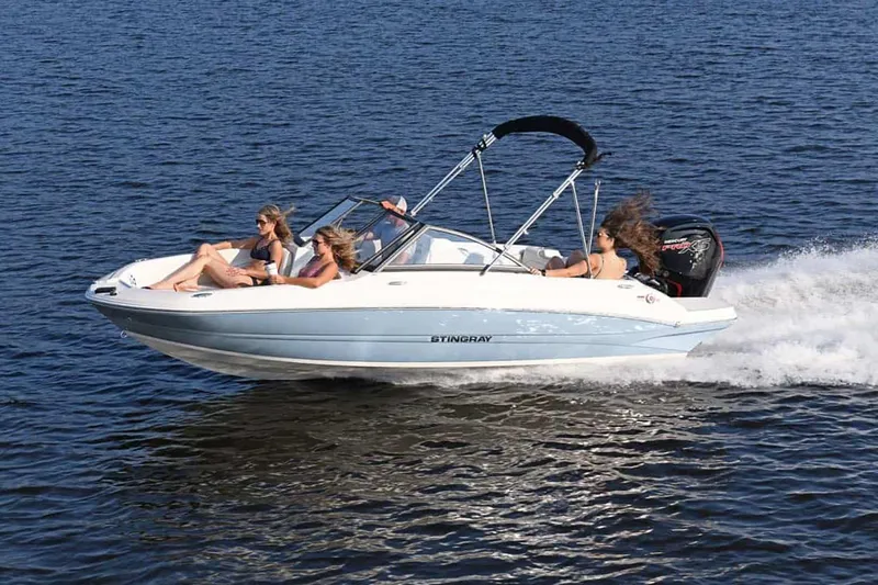 Slide: The Image of Manufacturer Provided Image: 2025 Stingray 191 DC boat cruising on open water with passengers. - 12