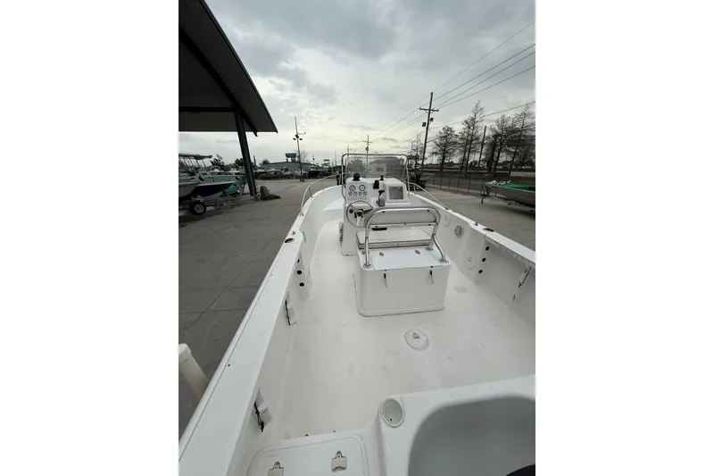 Slide: The Image of 2001 Pro-Line 22 Sport boat interior, featuring spacious deck and control console under cloudy skies. - 10