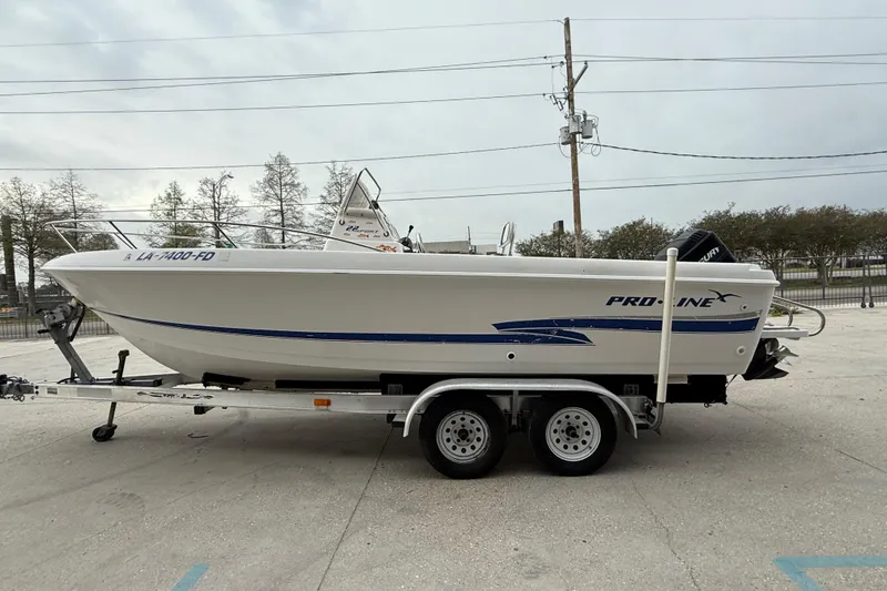 Slide: The Image of 2001 Pro-Line 22 Sport boat on trailer, side view, outdoors. - 7