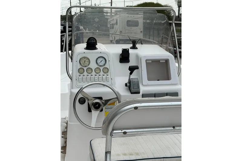 Slide: The Image of 2001 Pro-Line 22 Sport boat dashboard with steering wheel and gauges. - 9