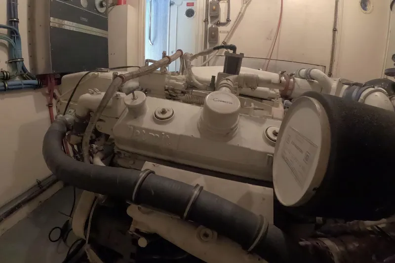 Slide: The Image of Engine room of a 1987 Hatteras 54 Motor Yacht, showcasing mechanical components. - 100