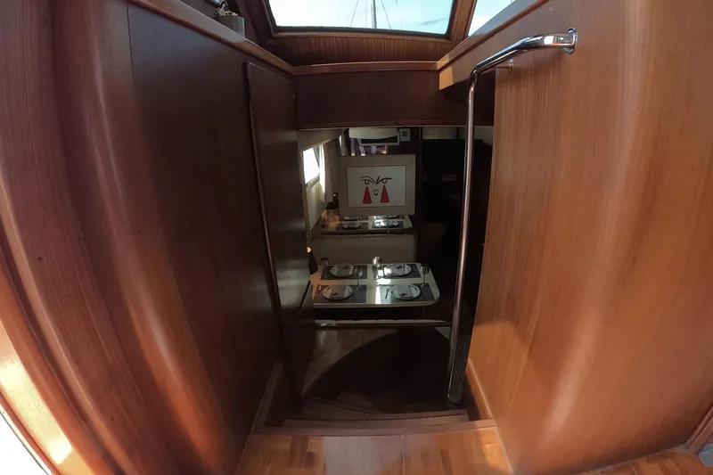 Slide: The Image of Interior view of 1987 Hatteras 54 Motor Yacht with wooden paneling and dining area. - 106