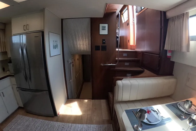 Slide: The Image of Interior of 1987 Hatteras 54 Motor Yacht with modern kitchen and dining area. - 12