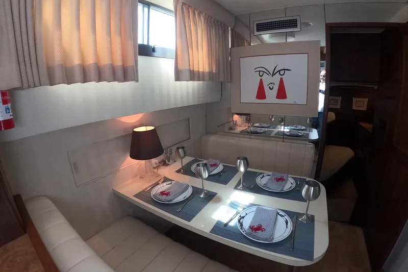Slide: The Image of Elegant dining area in a 1987 Hatteras 54 Motor Yacht with modern decor. - 14