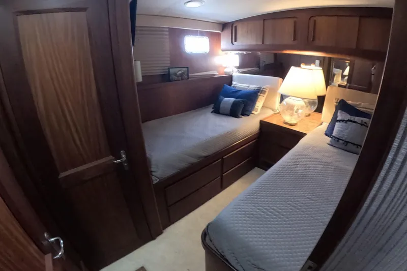 Slide: The Image of Cozy cabin interior of 1987 Hatteras 54 Motor Yacht with twin beds and wooden furnishings. - 20