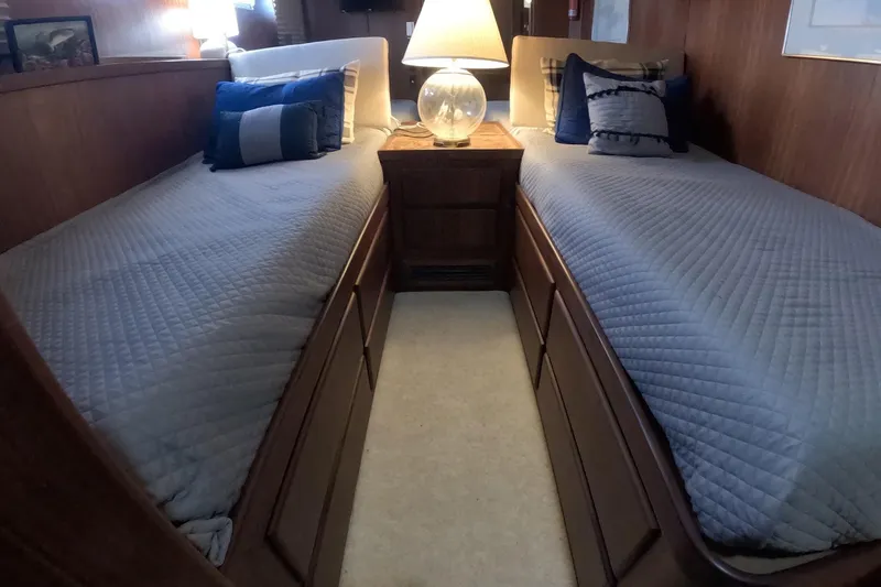 Slide: The Image of Interior of 1987 Hatteras 54 Motor Yacht with twin beds and cozy decor. - 21