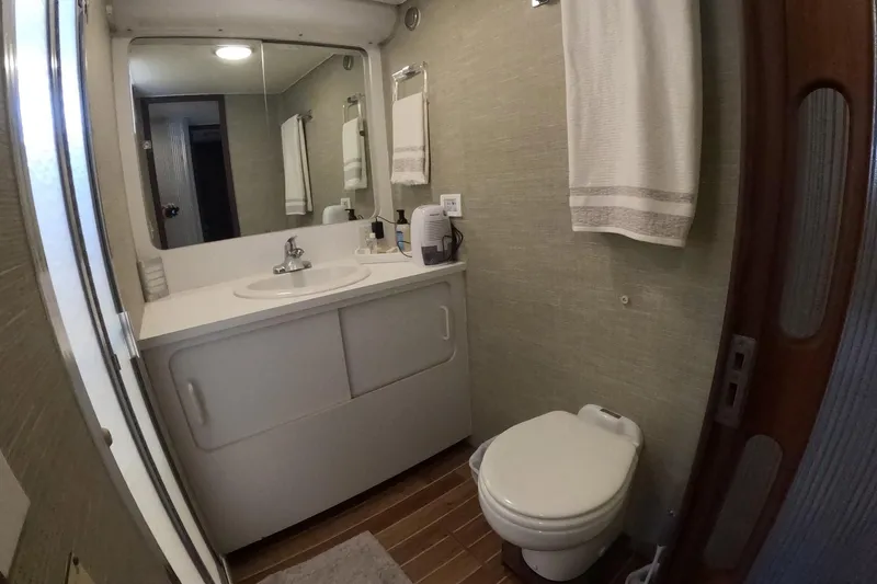Slide: The Image of Bathroom interior of 1987 Hatteras 54 Motor Yacht with sink, mirror, and toilet. - 23