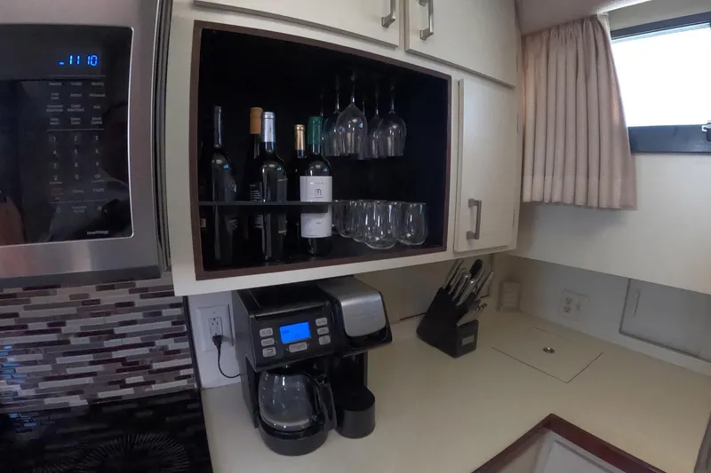 Slide: The Image of Kitchen area of a 1987 Hatteras 54 Motor Yacht with wine storage and coffee maker. - 34