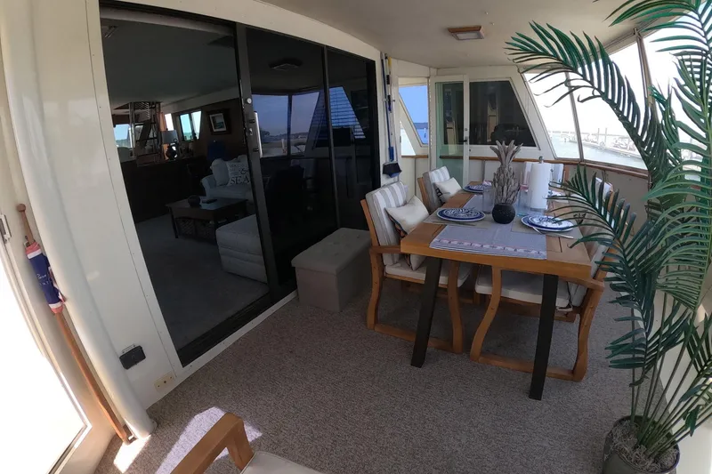 Slide: The Image of 1987 Hatteras 54 Motor Yacht interior with dining area and decorative elements. - 38