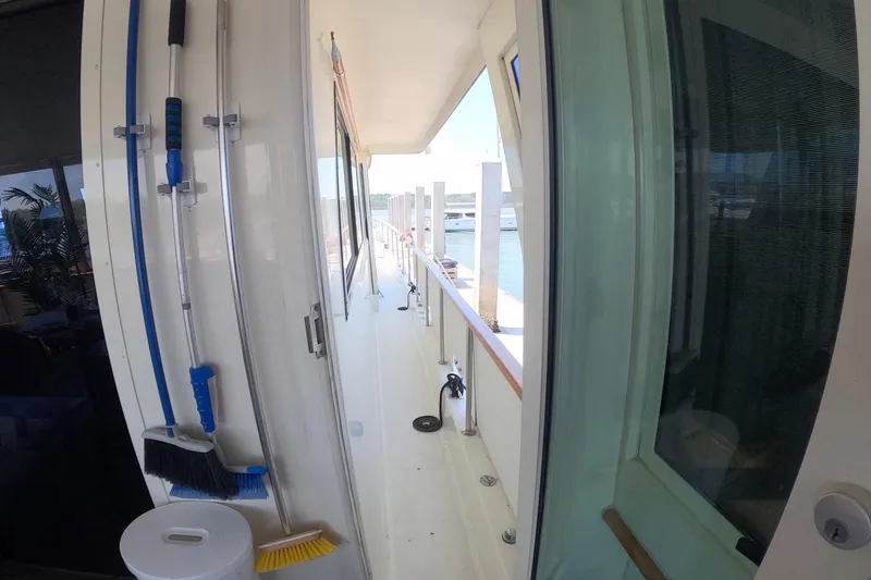 Slide: The Image of Narrow deck view of 1987 Hatteras 54 Motor Yacht with cleaning tools. - 41