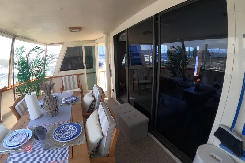 Slide: The Image of Elegant dining area on a 1987 Hatteras 54 Motor Yacht with nautical decor. - 42