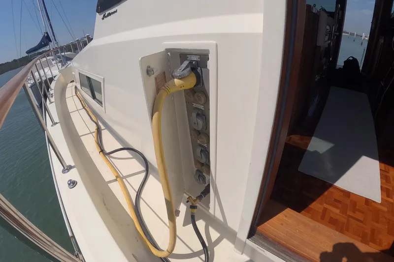 Slide: The Image of 1987 Hatteras 54 Motor Yacht electrical panel with cables on deck. - 45