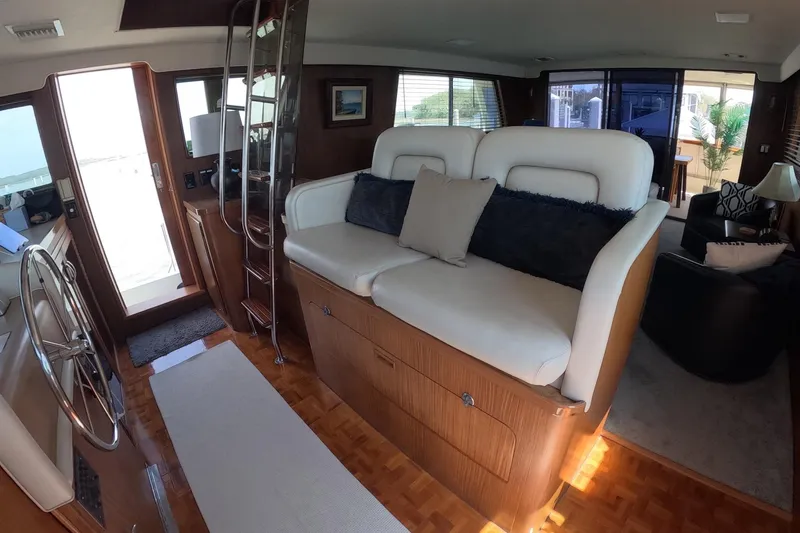 Slide: The Image of Interior of 1987 Hatteras 54 Motor Yacht with plush seating and wooden accents. - 5