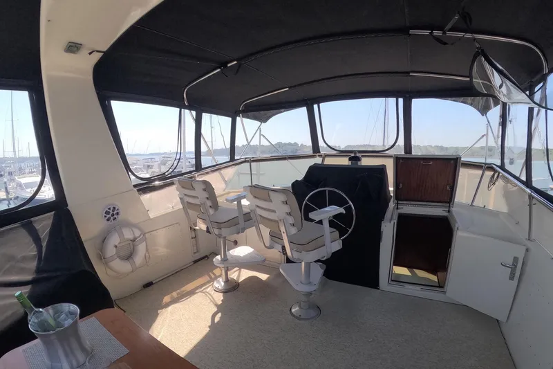 Slide: The Image of Interior view of 1987 Hatteras 54 Motor Yacht helm with seating and controls. - 57