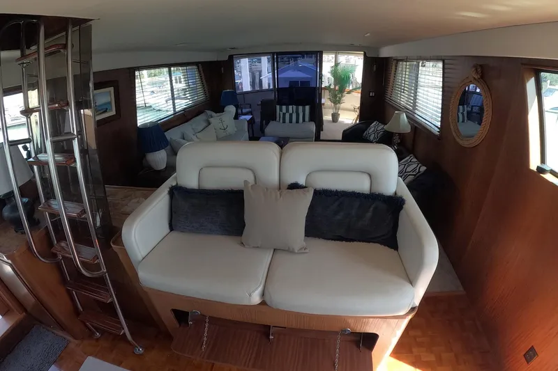 Slide: The Image of Interior of 1987 Hatteras 54 Motor Yacht with elegant seating and decor. - 60