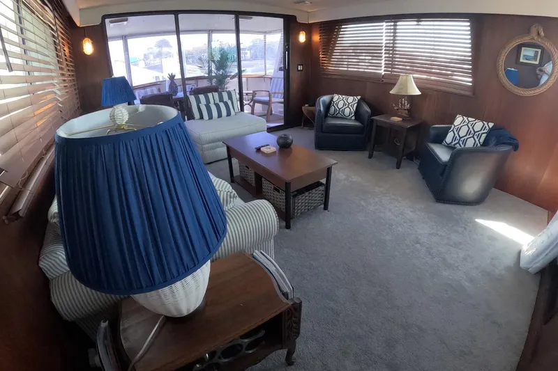 Slide: The Image of Luxurious interior of a 1987 Hatteras 54 Motor Yacht with elegant seating and nautical decor. - 61