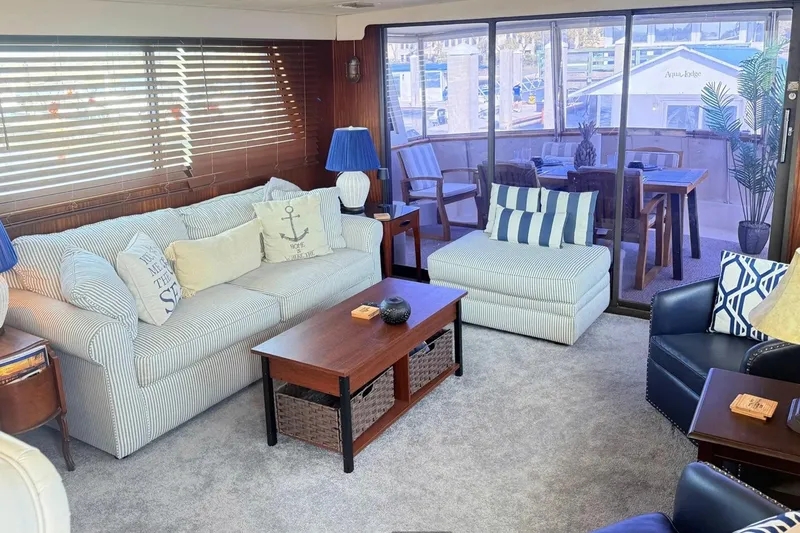 Slide: The Image of Interior of 1987 Hatteras 54 Motor Yacht with cozy seating and nautical decor. - 65