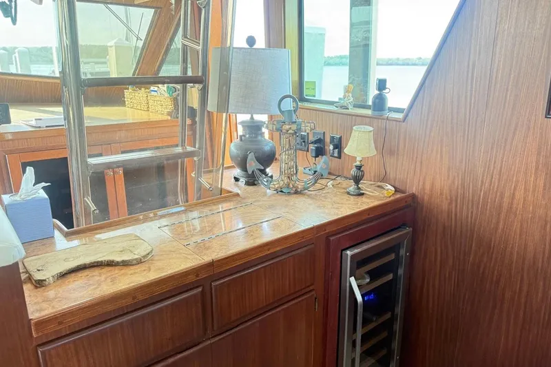 Slide: The Image of Interior of 1987 Hatteras 54 Motor Yacht with wooden cabinetry and decorative lamps. - 66