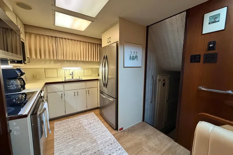Slide: The Image of Interior of 1987 Hatteras 54 Motor Yacht kitchen with modern appliances and cozy decor. - 68