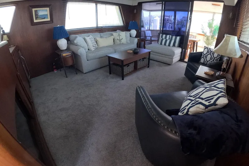 Slide: The Image of Interior of 1987 Hatteras 54 Motor Yacht with cozy seating and nautical decor. - 7