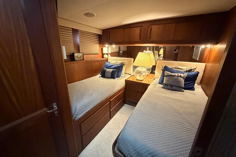 Slide: The Image of Cozy twin cabin in 1987 Hatteras 54 Motor Yacht with elegant wood paneling. - 72