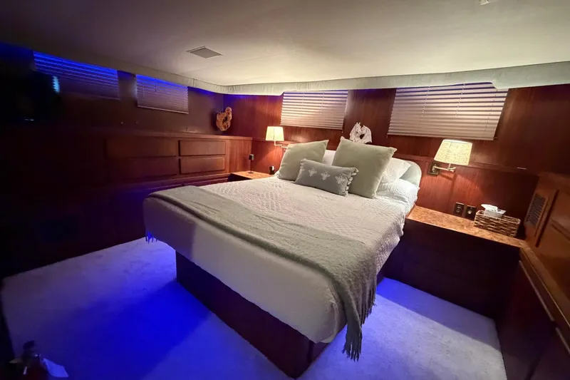 Slide: The Image of Luxurious bedroom interior of 1987 Hatteras 54 Motor Yacht with ambient lighting. - 73