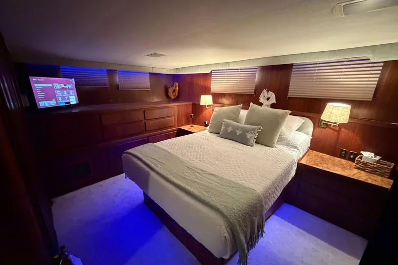 Slide: The Image of Luxurious bedroom interior of 1987 Hatteras 54 Motor Yacht with ambient lighting. - 74