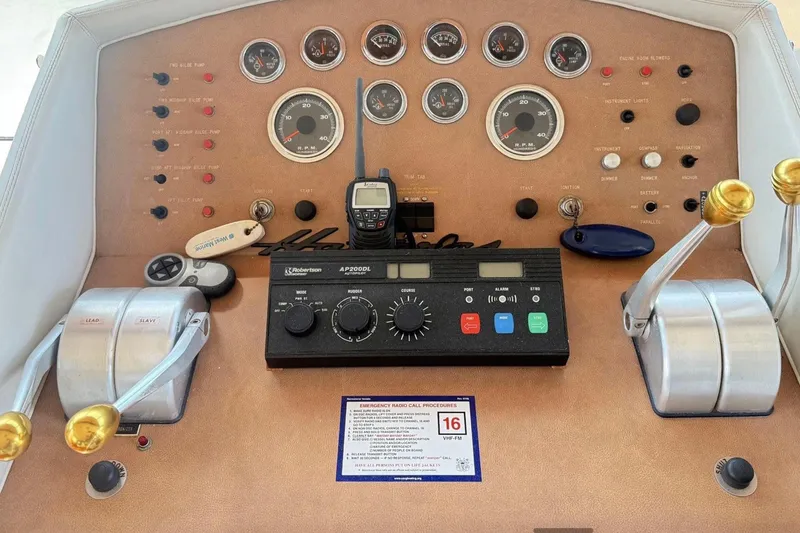 Slide: The Image of Control panel of a 1987 Hatteras 54 Motor Yacht with gauges and levers. - 75