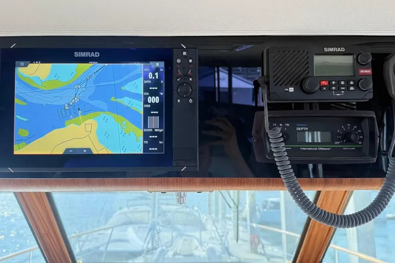 Slide: The Image of Navigation equipment on a 1987 Hatteras 54 Motor Yacht, featuring Simrad displays. - 76