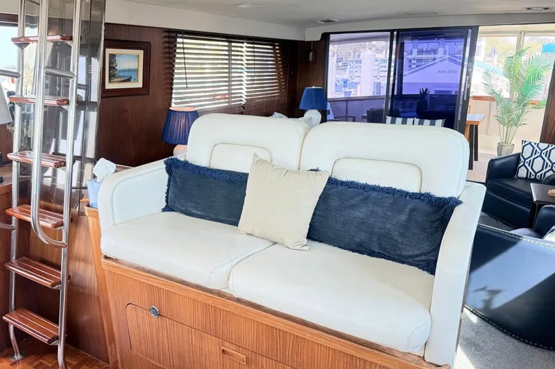 Slide: The Image of Interior of 1987 Hatteras 54 Motor Yacht with white sofa and nautical decor. - 77